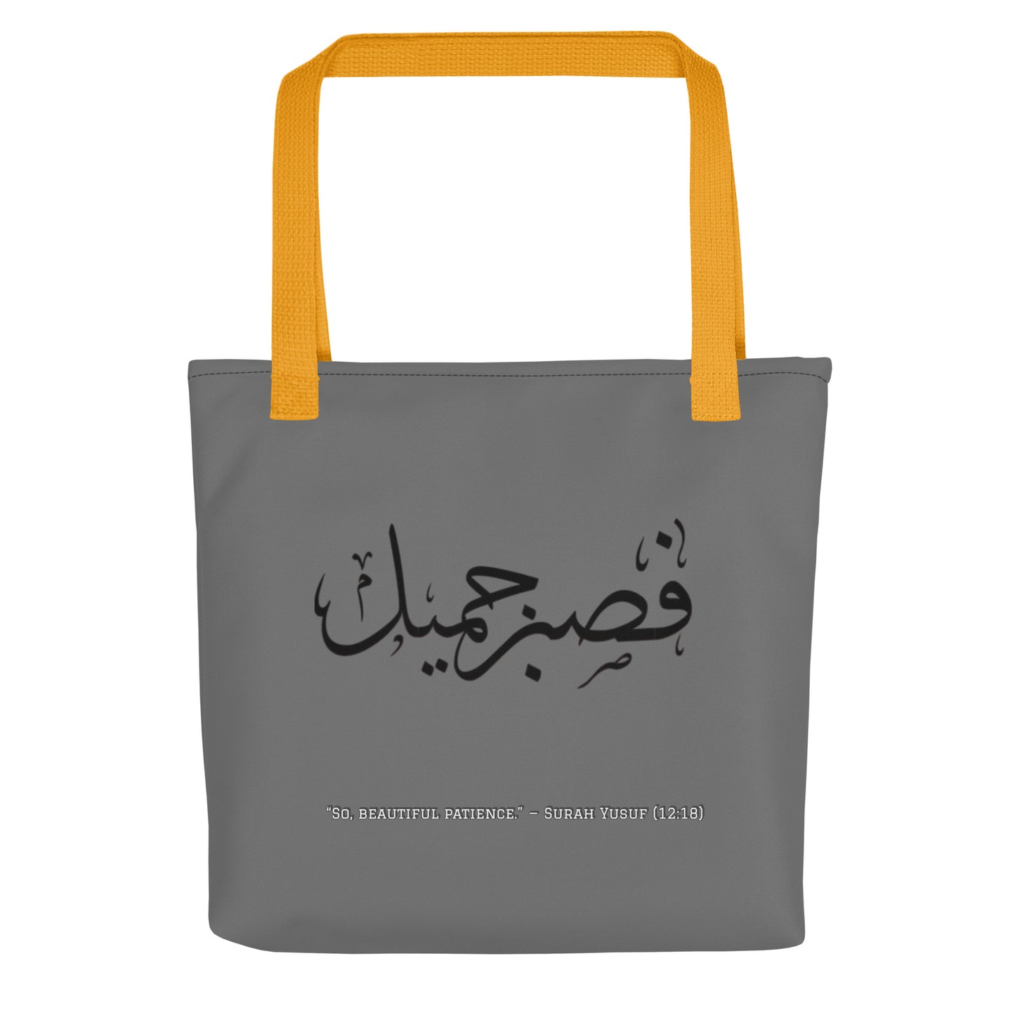 Gray tote bag with yellow handles and Arabic text on a white background
